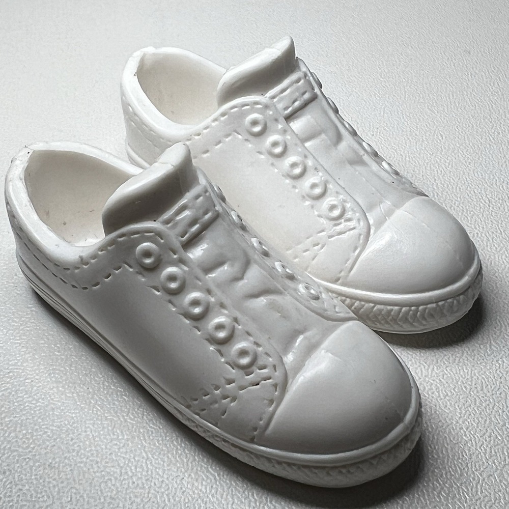 white plastic toy sneakers designed to fit a Ken or similar 12-inch doll